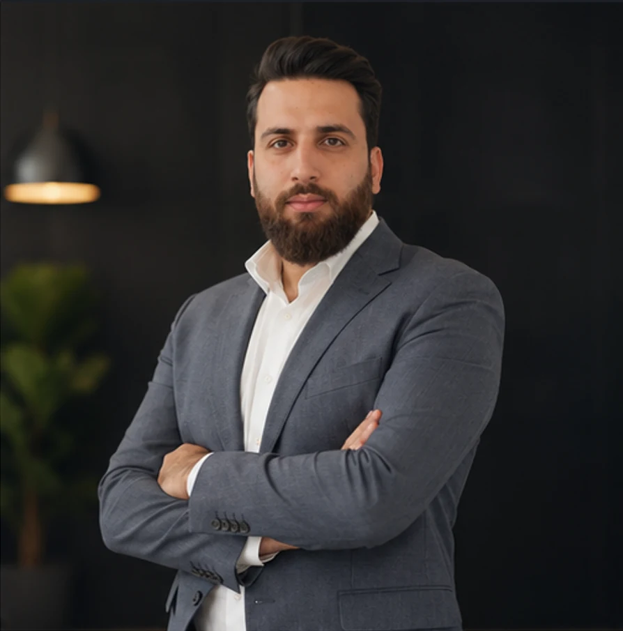 Hossein Barzegar in a professional standing portrait.
